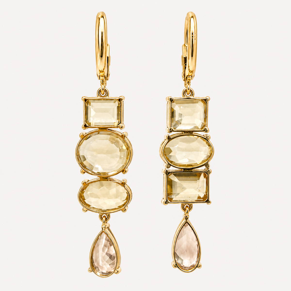 Back view of the Almaza zircon earrings, showing open gold gemstone settings, articulated links and hinged clasps.