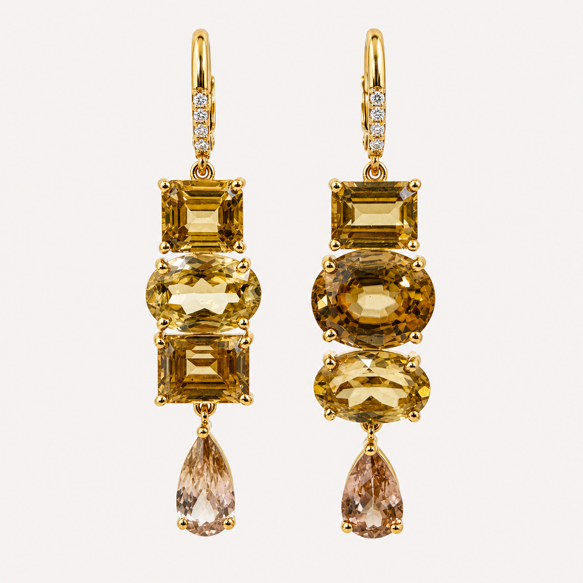 Front view of the Almaza earring pair, with assorted golden zircon cuts, pale teardrop ends and diamond-set 18K gold clasps.