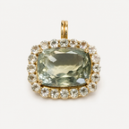 Front view of the Amira pendant: cushion-cut olive green amethyst surrounded by white sapphires in 18K gold.