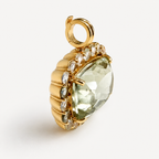 Angled view of the Amira green amethyst pendant, showing its deep 18K gold setting, white sapphire border and hinged bail.