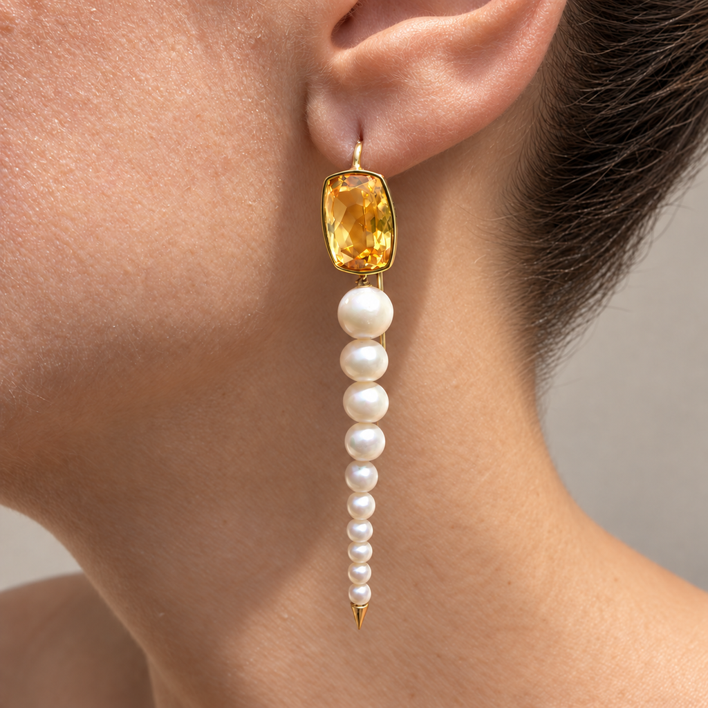 Anoud citrine and pearl drop earring in 18K gold, shown worn on the ear.