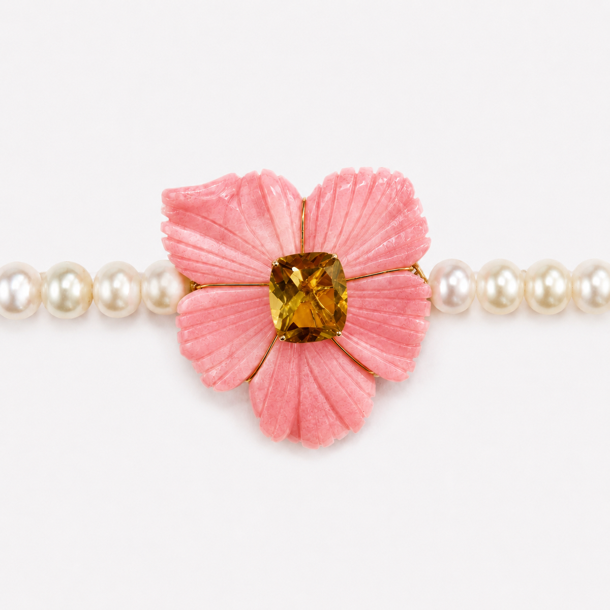 Close-up of the Bianca choker, showing five carved pink opal petals around a golden citrine centre between white pearls.