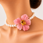 Bianca choker worn on a model, with a carved pink opal flower and golden citrine centre on a white pearl strand.