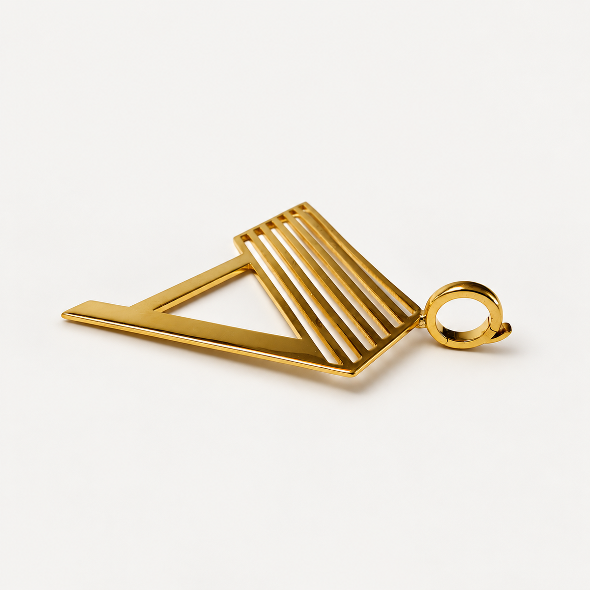 Angled view of the 18K gold Deco initial A pendant showing its openwork design and round offset clasp.