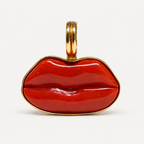 Front view of the Dina pendant, with hand-carved red Italian coral lips framed in polished 18K gold.