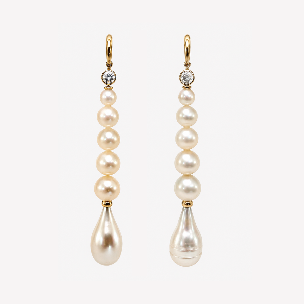 Pair of Farah earrings with white sapphires, graduated round freshwater pearls and teardrop pearl ends in 18K gold.