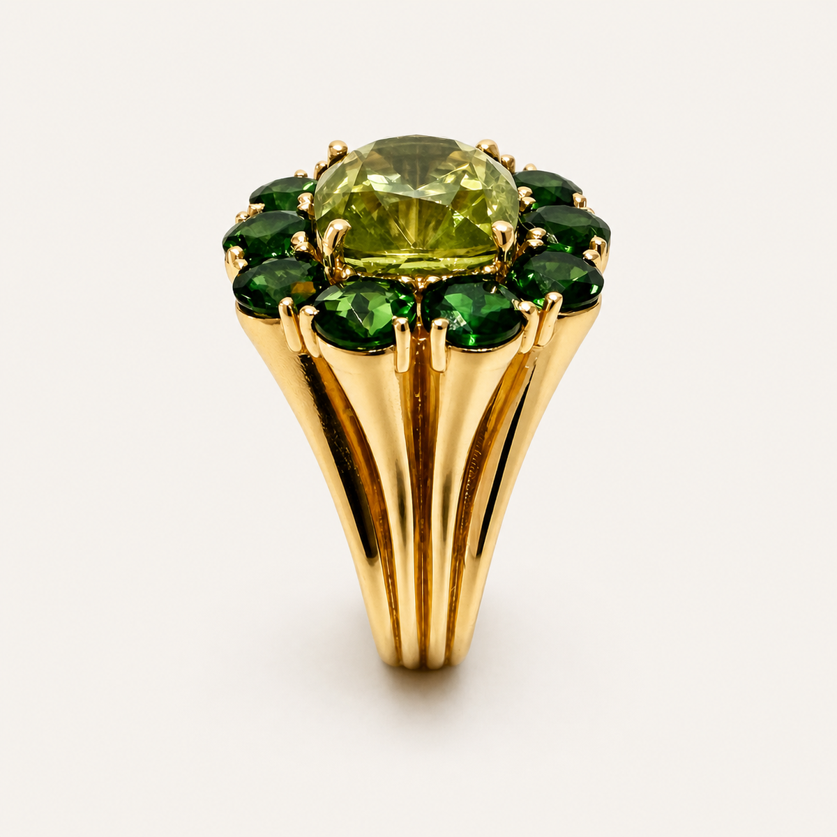 End view of the Fleur peridot and chrome diopside ring, showing the fluted 18K gold shoulders beneath the green gemstone cluster.