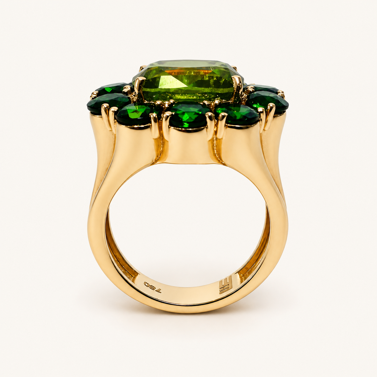 Side view of the Fleur ring, showing the raised peridot, chrome diopside halo and scalloped 18K gold band.