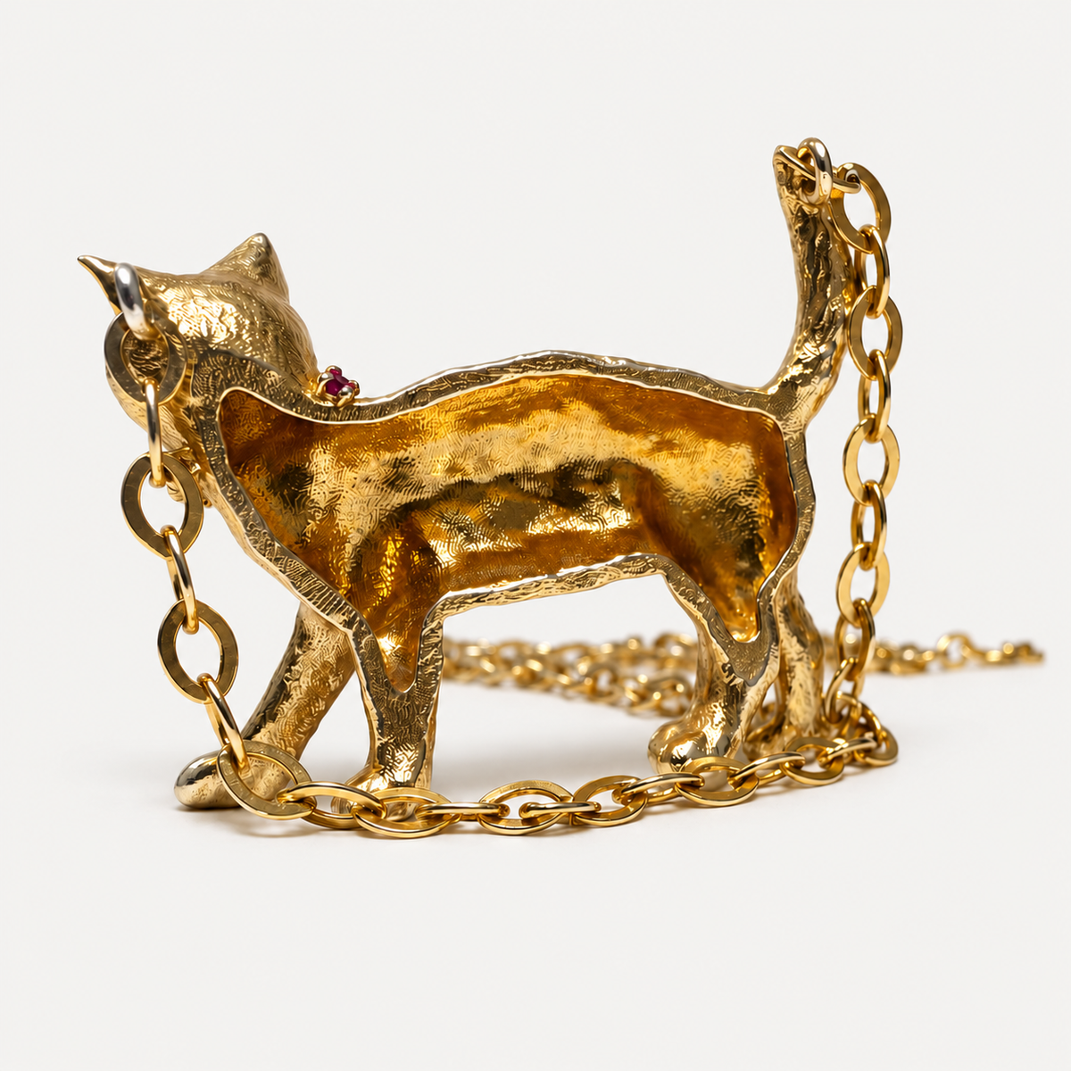 Reverse of the Gigi 18K gold cat pendant, showing its hollow back and chain attachment loops.