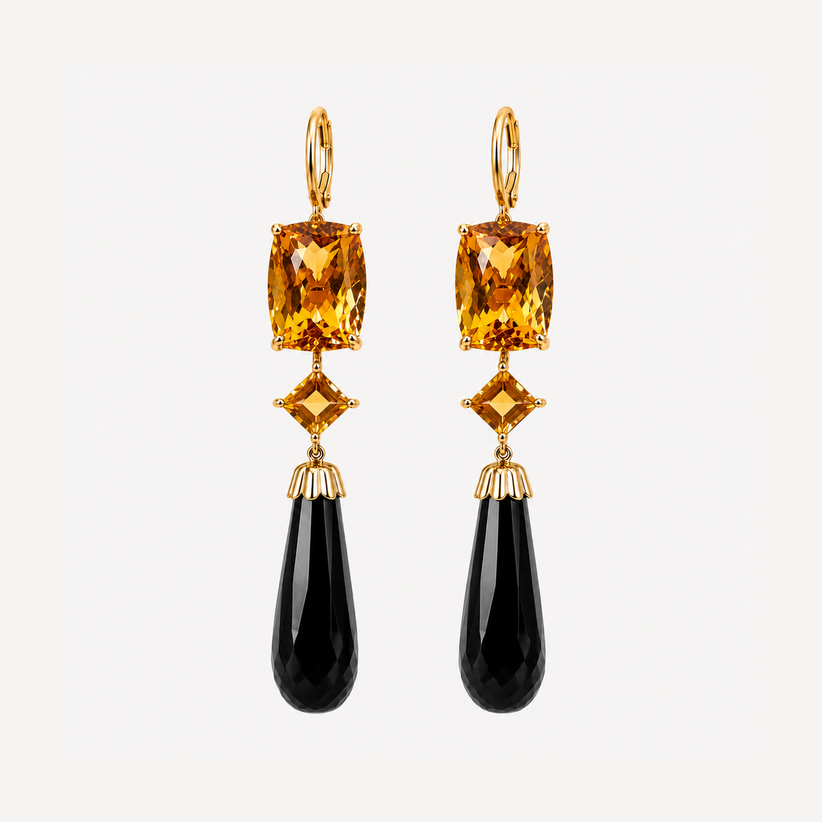 Pair of Lara earrings with rectangular and diamond-shaped golden citrines above faceted black onyx drops in 18K gold.