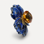 Side view of the Margo flower pendant, showing carved lapis lazuli petals and a raised citrine centre in gold.