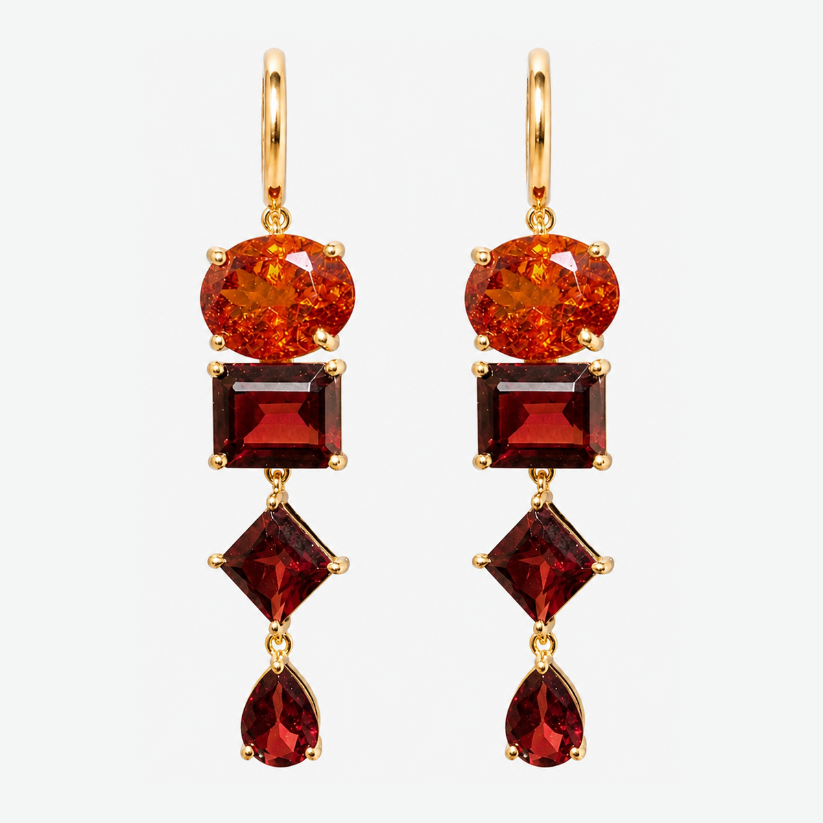 Pair of Nathalie 18K gold earrings, each with an orange-red oval garnet above three deep red garnets in square, diamond and pear shapes.