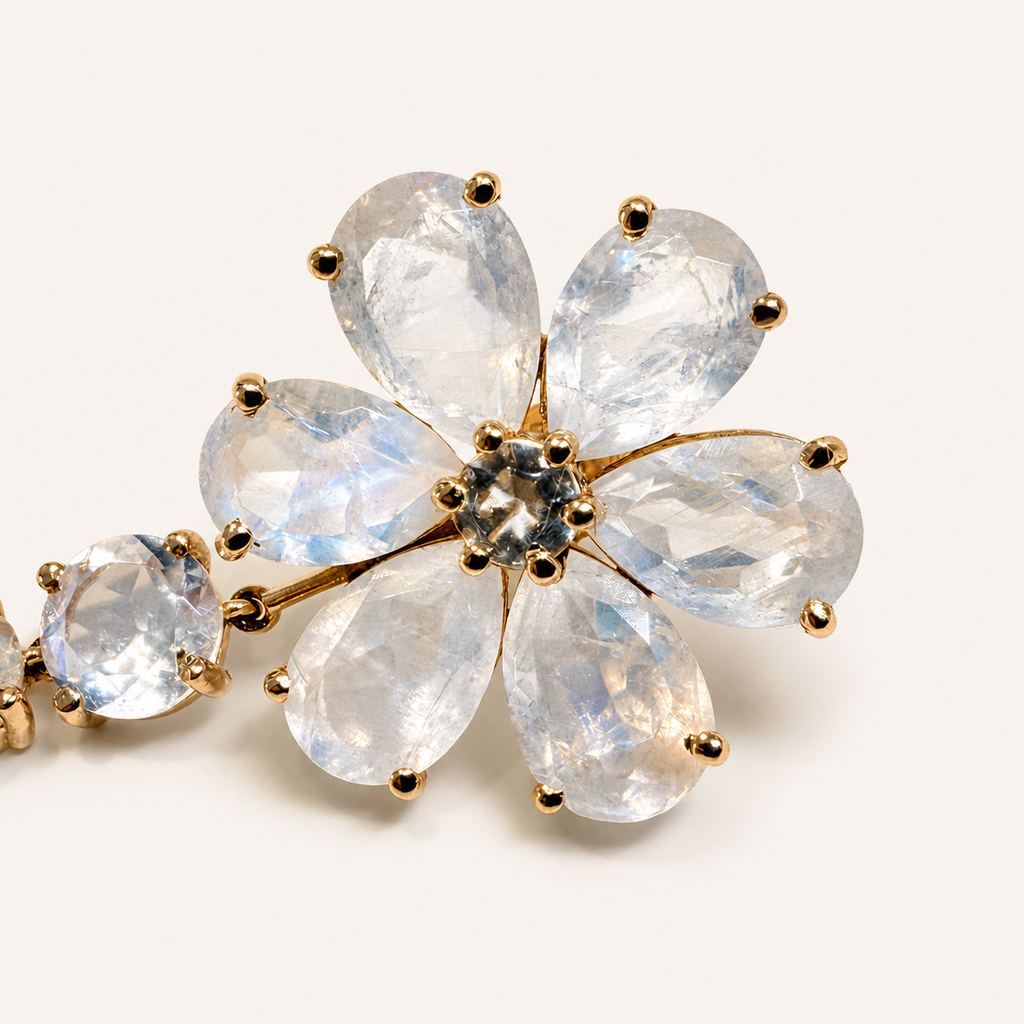 Close-up of the Nayla earring flower, showing six pear-shaped rainbow moonstone petals held in 18K gold claws.