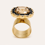 Upright side view of the Paloma morganite and blue sapphire ring, showing the elevated cluster setting and wide gold band.
