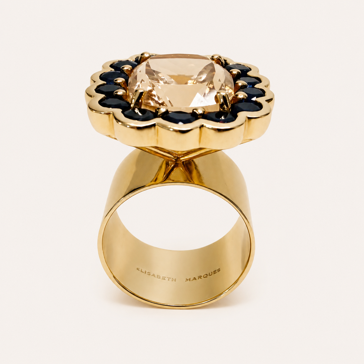 Upright side view of the Paloma morganite and blue sapphire ring, showing the elevated cluster setting and wide gold band.