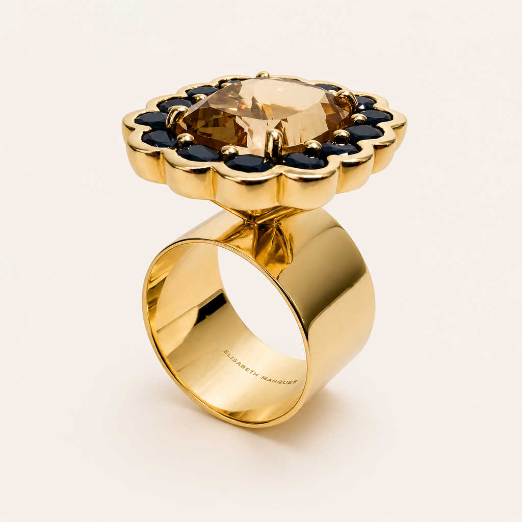Angled view of the Paloma ring, showing the raised morganite, scalloped blue sapphire halo and broad polished 18K gold band.