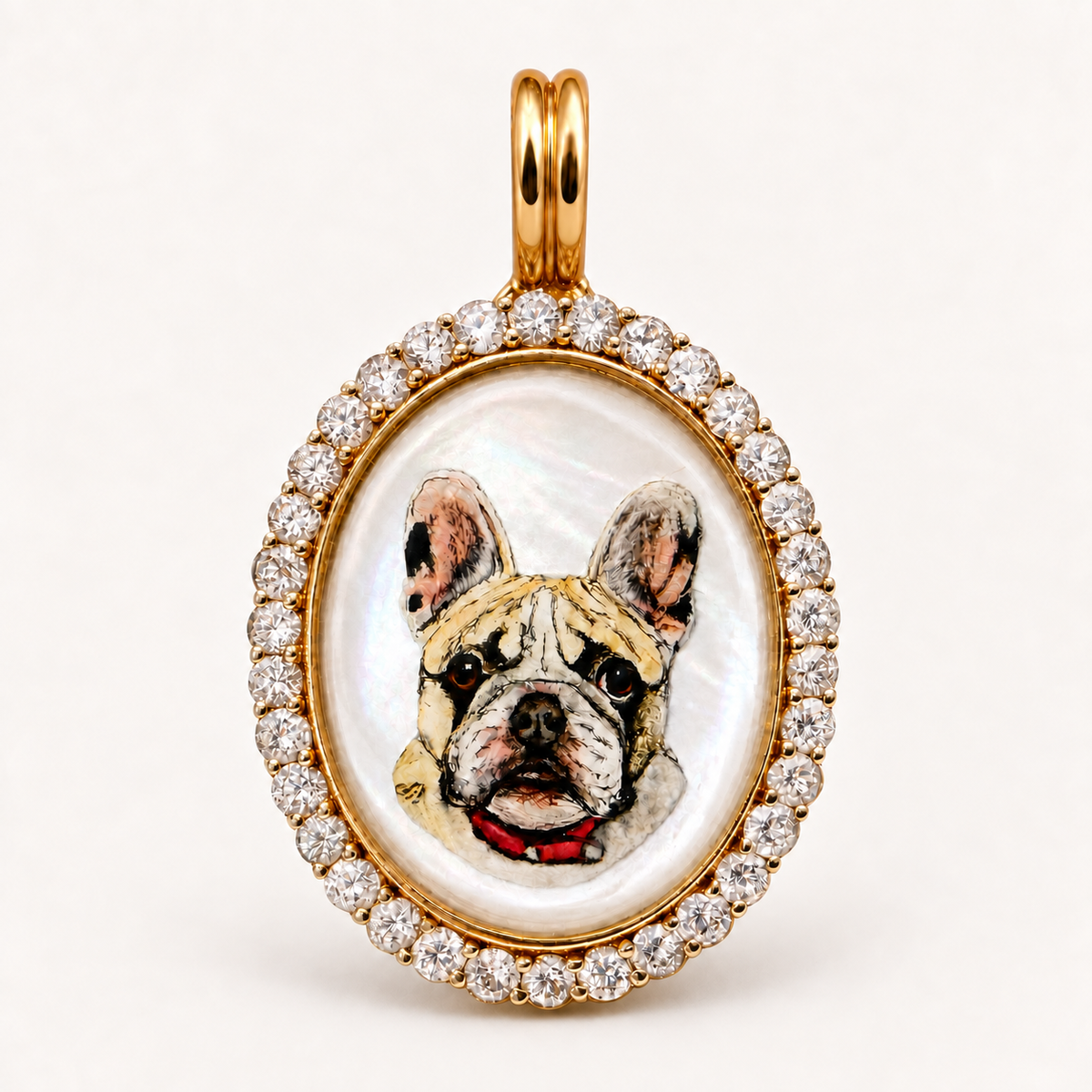 Front view of the pet portrait pendant: a hand-painted French bulldog in oval rock crystal, framed in gold and clear gemstones.