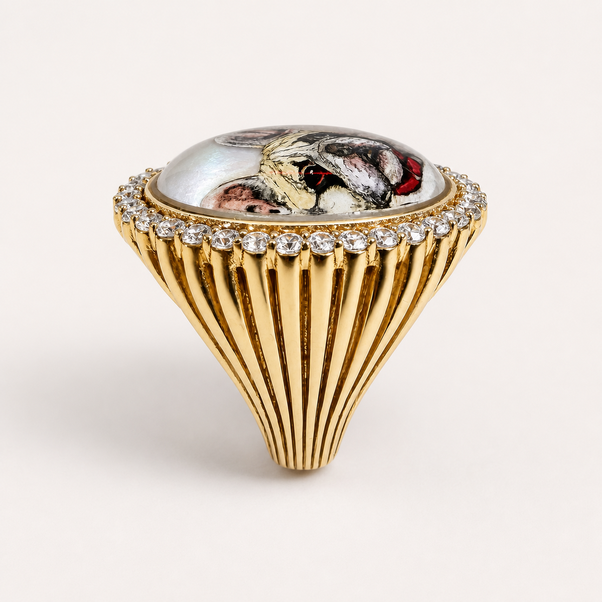 Side profile of the pet portrait ring, showing the domed rock crystal portrait, clear gemstone rim and tapering fluted gold shoulder.