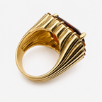 Back of the Raj ring, showing the wide fluted 18K gold band and open underside beneath the garnet setting.