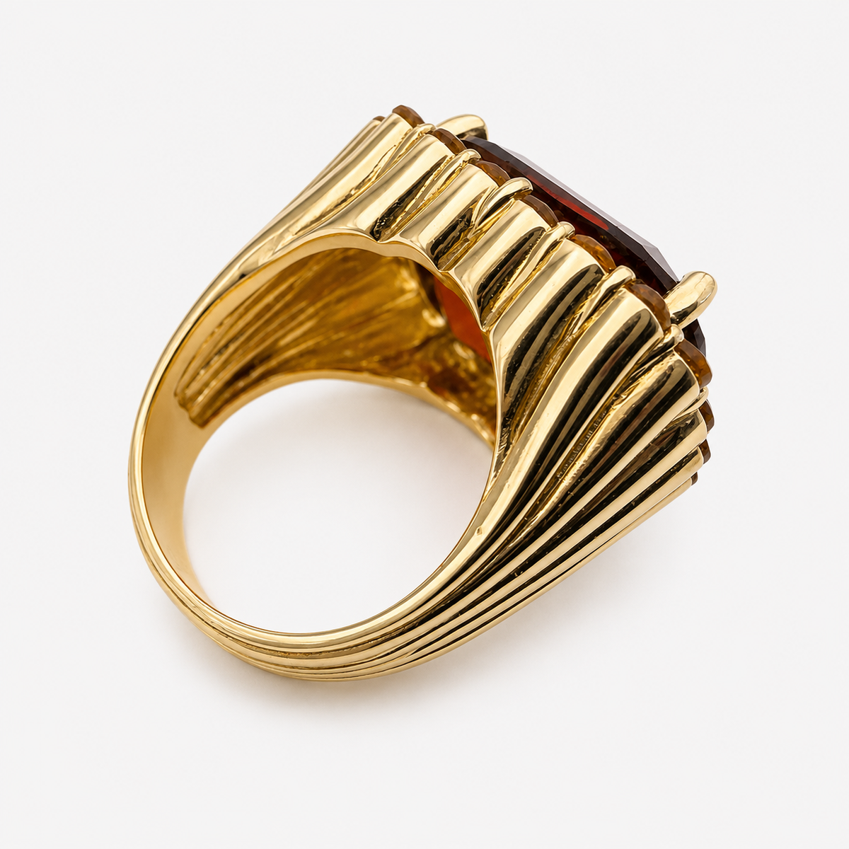 Back of the Raj ring, showing the wide fluted 18K gold band and open underside beneath the garnet setting.