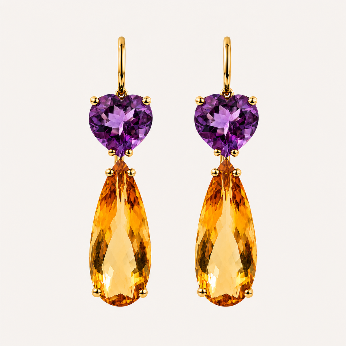 Pair of Roubini 18K gold earrings with heart-shaped purple amethysts and elongated pear-shaped golden citrine drops.