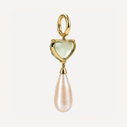 Back of a Sandy earring, showing the open gold heart-shaped gemstone setting, hinged hoop and freshwater pearl drop.