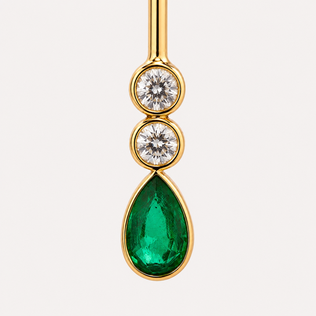 Close-up of the Serena earring gemstones: two round aquamarines above a pear-shaped green emerald, framed in polished 18K gold.