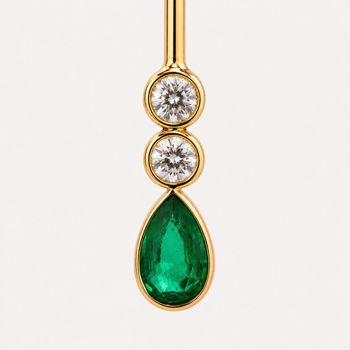 Close-up of the Serena earring gemstones: two round aquamarines above a pear-shaped green emerald, framed in polished 18K gold.