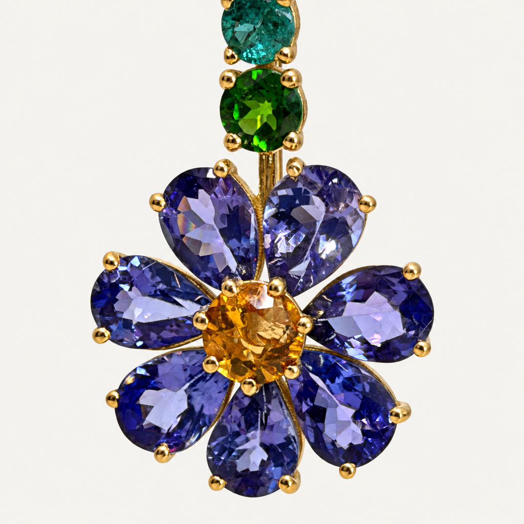 Close-up of the Violette tanzanite flower with pear-shaped purple petals, a citrine centre and green gemstones in gold claws.