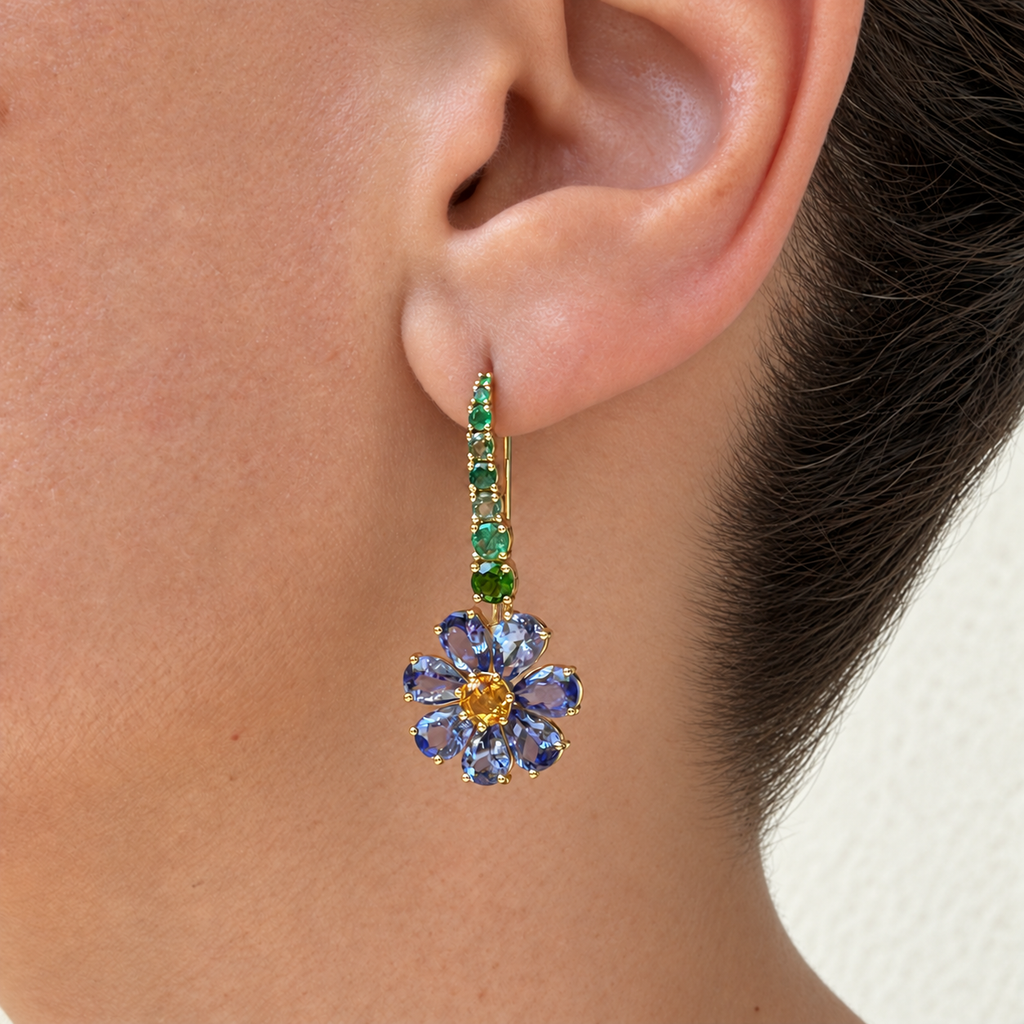 Short Violette earring worn on the ear, with a green gemstone bar and a tanzanite flower with a citrine centre.